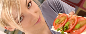 blond, young girl, woman eating a tomato sandwich